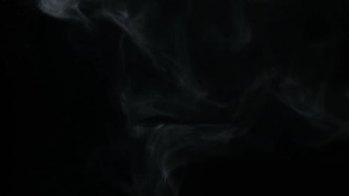 Wispy Smoke Billowing Against Black Background