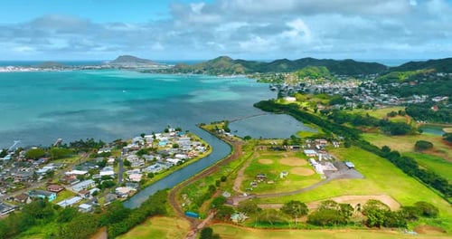 Beautiful golf course surrounded by residential area. Drone flight above the scenery of Honolulu