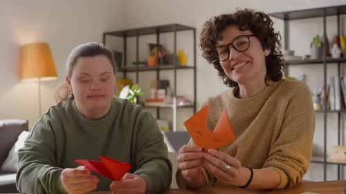 Smiling Women Making Paper Crafts Together Indoors