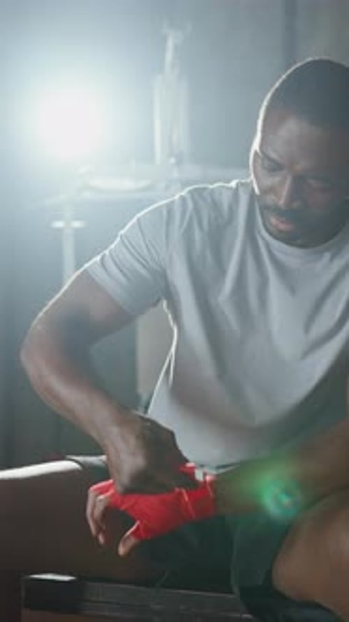 Box Fighter Wrapping Hands By Tape for Protection During Training in Gym Vertical Portrait of