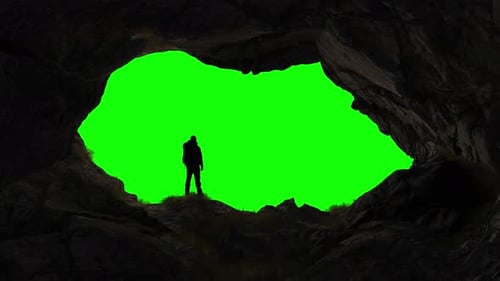 Adventure Man Hiker Standing in an Ice Cave on Top of Mountain Composite Cutout with Green Screen