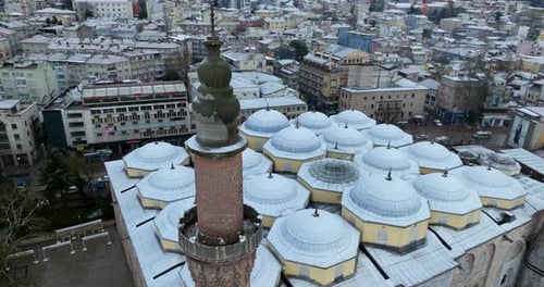 Grand Mosque Of Bursa Under The Fresh Snow In Turkey - aerial drone shot