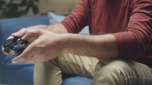 Adult Using Video Game Controller While Relaxing