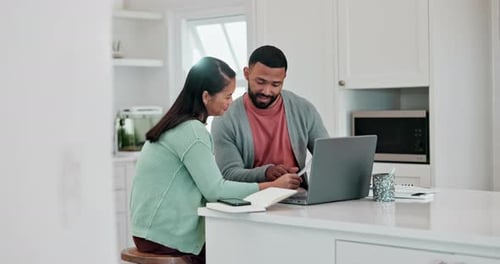Couple Discussing Finances with Laptop in Kitchen