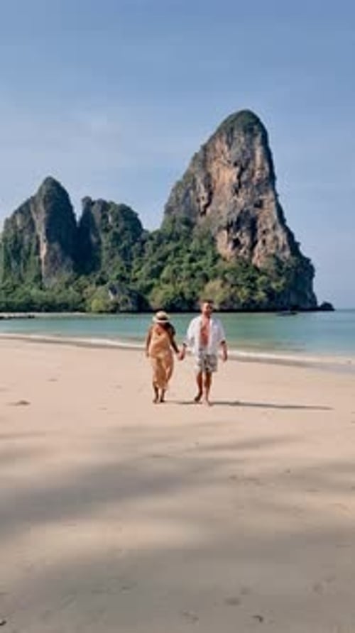 Strolling Hand in Hand on the Serene Sands of Railay Beach in Krabi Thailand