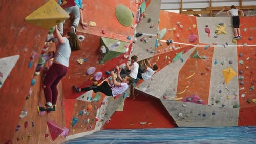 Children and Adult Enjoy Rock Climbing at Gym