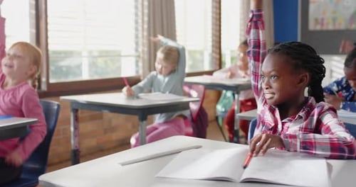 In school, students raising hands and participating actively in classroom activities
