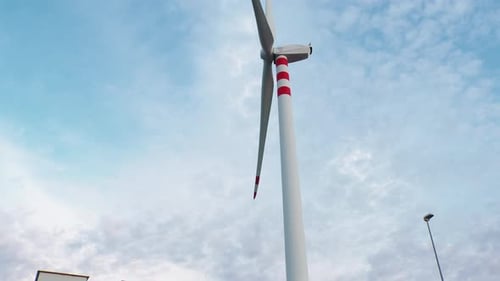 Wind Turbine is Moving Slow Under Blue Sky