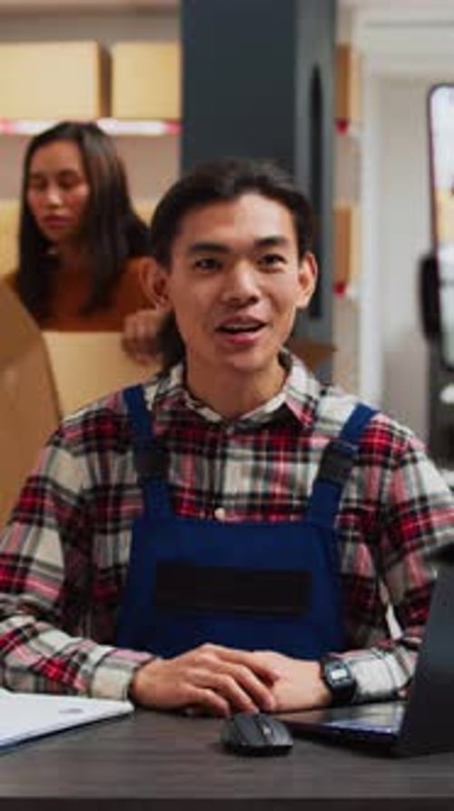 Vertical Video Male Employee Filming Promotion Video in Warehouse
