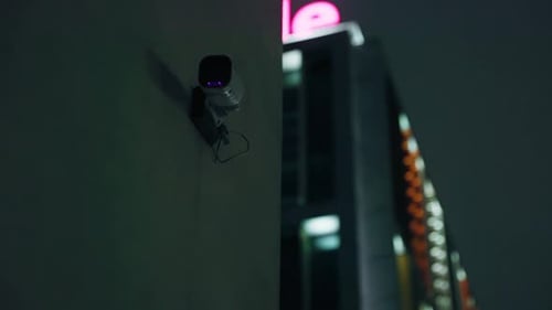 Establishing Shot A CCTV Camera in the City at Night Ensures Safety and Security