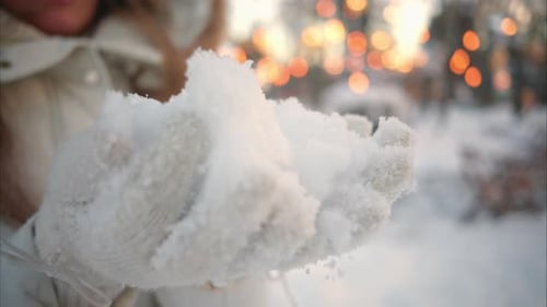 Young Woman Holding Snow in Winter Park