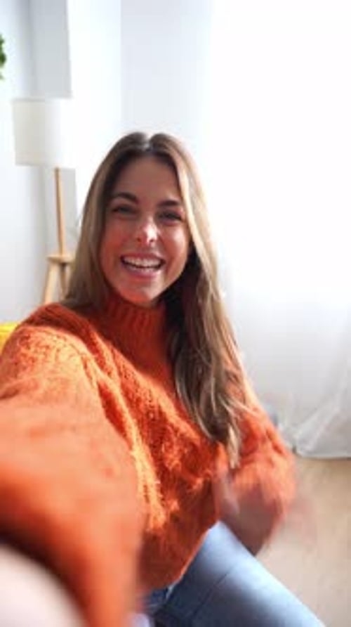 Young Woman Waving and Talking Indoors