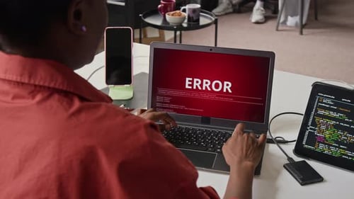 Black Female Software Developer Facing System Error on Laptop