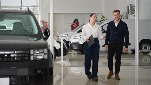 Car Saleswoman Explaining Vehicle Features to Potential Buyer