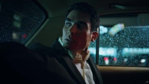 Man in Suit Rides in Car at Night