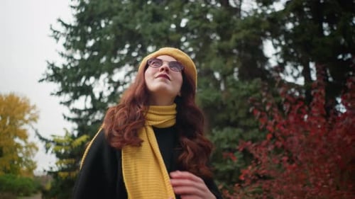 Elegant Lady in Yellow Beret Gazing Up in Autumn Park