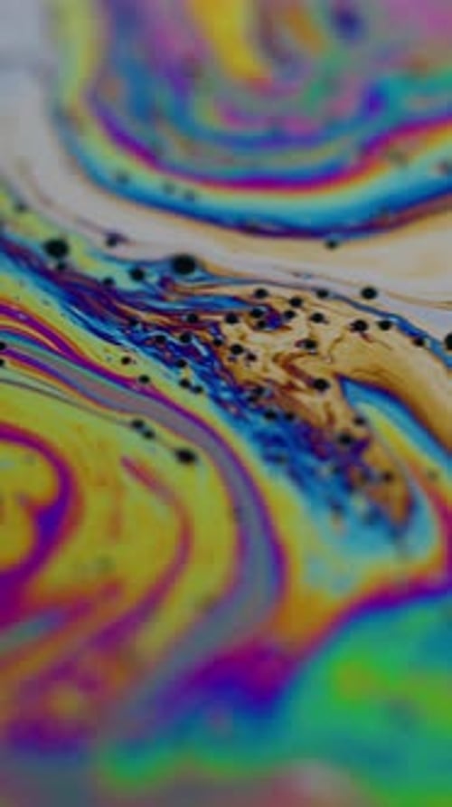 Swirling iridescent colors and patterns in a liquid