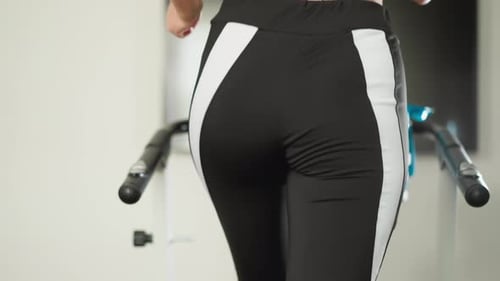Sportswoman Walks on Treadmill in Apartment