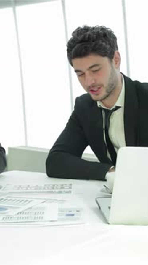 Engaging Dialogue Between Young Professionals in a Sleek Office Setting
