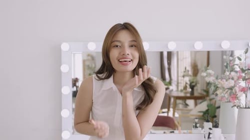 Asian young woman gently applying lip balm to lips during morning beauty