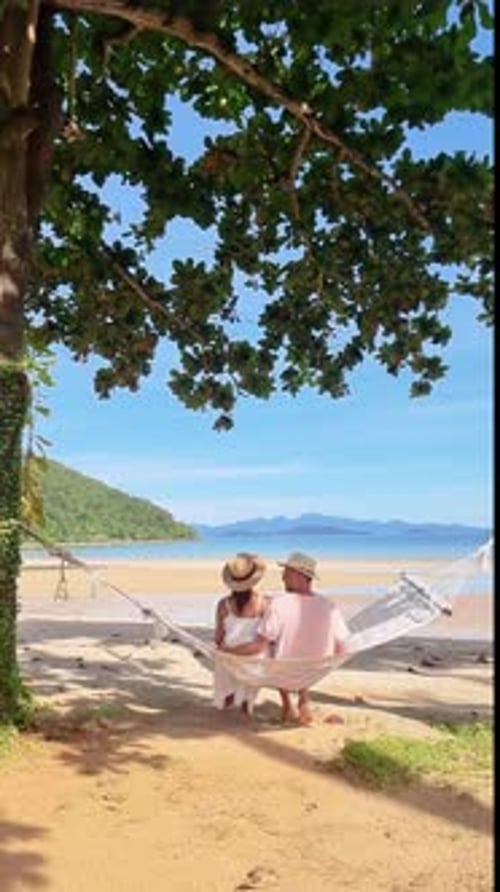 a Couple is Sitting in a Hammock on the Beach Koh Kood Thailand