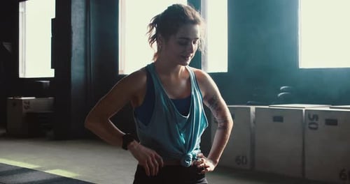 Sweaty Woman with Ponytail Resting after Workout