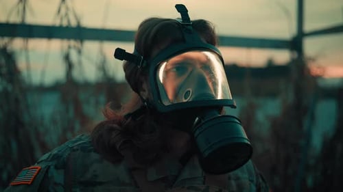 Person in Gas Mask Outdoors During Golden Hour