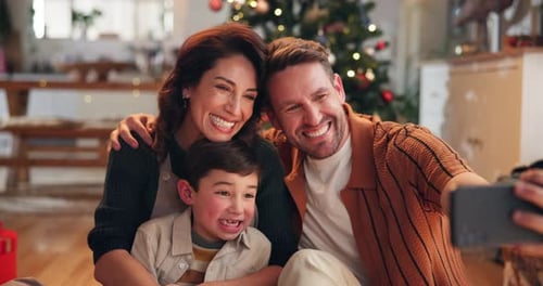 Happy Family Taking Christmas Selfie At Home