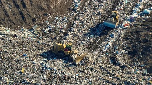 Bulldozers Working at a Large Landfill Site
