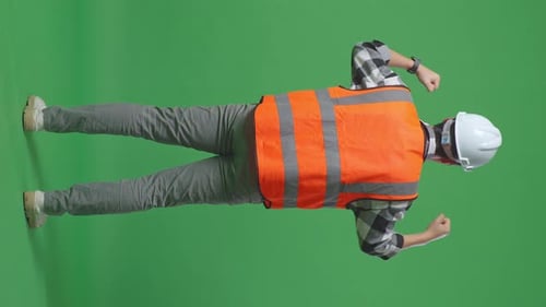 Back View Of A Male Engineer Raising His Hands Celebrating While Working In The Green Screen