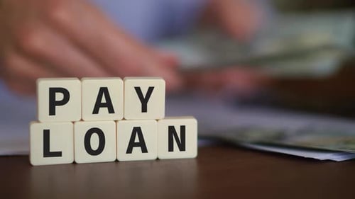 Pay Loan Lettering Next to Money Close Up