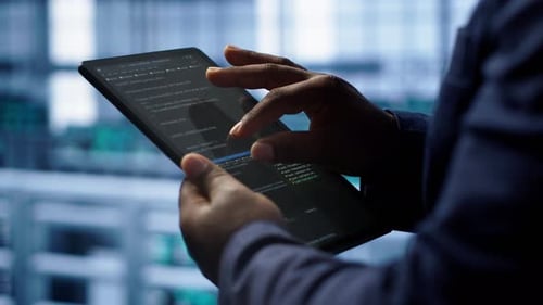 Close Up Shot of Worker in Server Room Using Tablet