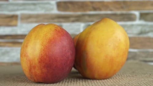 Ripe Nectarines on Burlap Surface