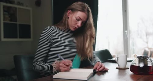 Girl is writing in a book