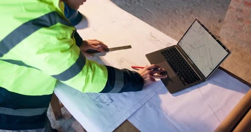 Blueprint, laptop and construction worker on site with design for building, repairs or renovation