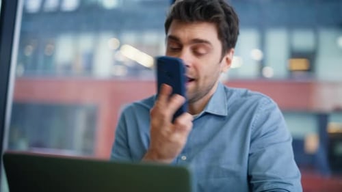 Man Talking on Phone at Desk in Modern Office