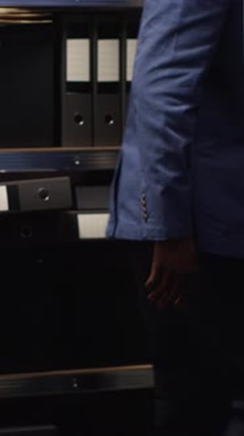 Man in Suit Reviews Documents in Office Setting