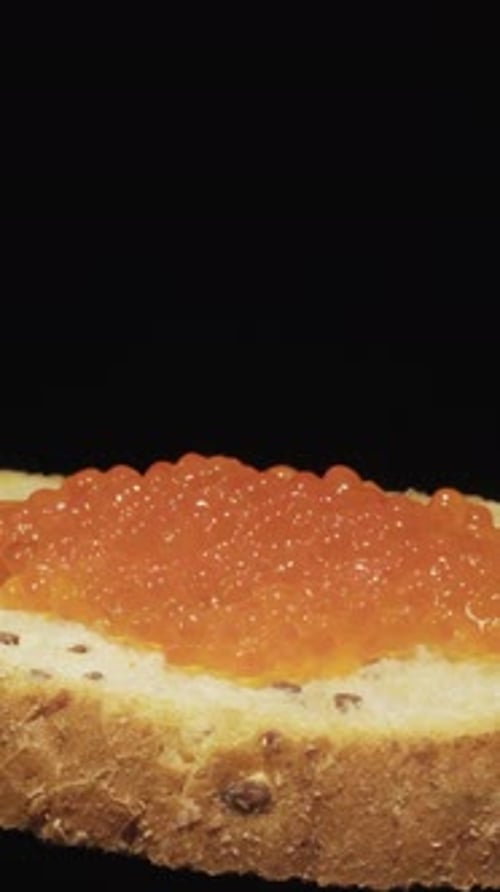 Caviar Being Added to Bread Slice