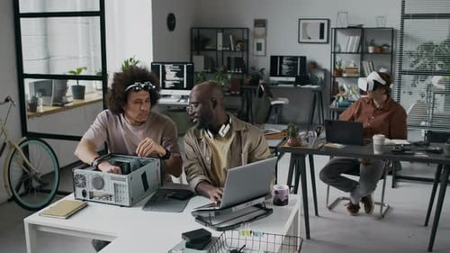 Three Men Working at Desks in a Modern Office