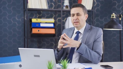 Man in Suit During Video Conference at Desk
