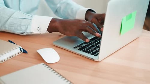 Adult Types on a Laptop at a Desk