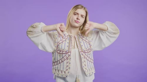 Young Woman Expressing Disapproval With Thumbs Down