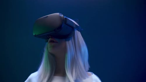 Young Woman Using VR Headset in a Dark Room