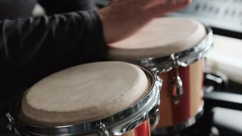 Musician Plays Bongos with Hands in Studio