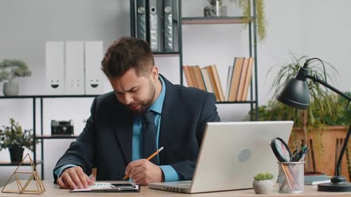 Businessman Working on Laptop Meditating Doing Yoga Breathing Exercise in Lotus Position at Office