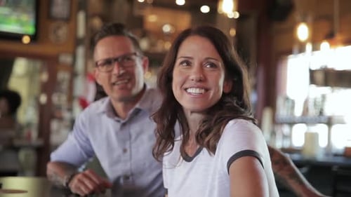 Couple Watching Game In Sports Bar