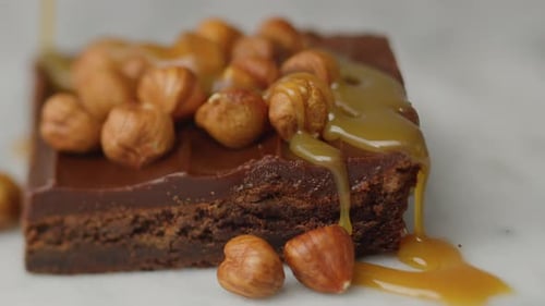 Caramel Being Poured Over a Hazelnut Chocolate Brownie