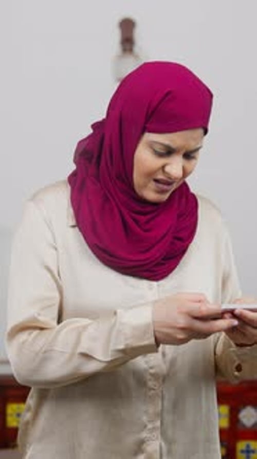 Woman Reacting Negatively to Phone Indoors