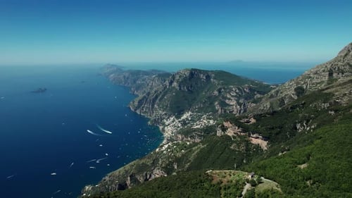 Aerial reveal of Amalfi town and coastline. Mountains overlooking the Amalfi Coast, Italy, with vast