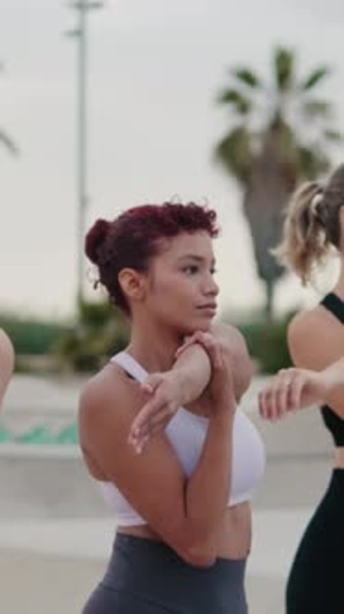 Young Women Stretching Arms Before Fitness Activity